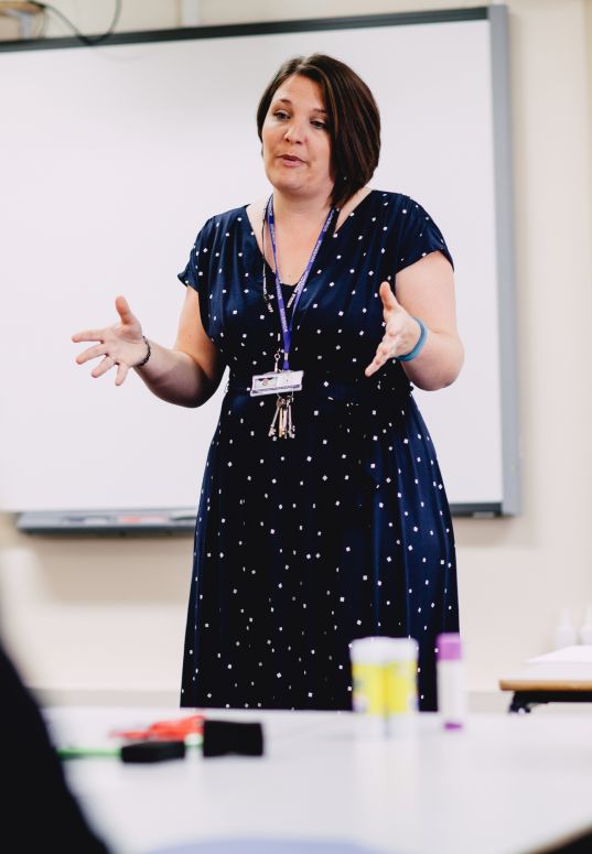 A teacher standing at the front of a classroom