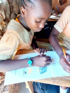 A child in Kenya completing classwork